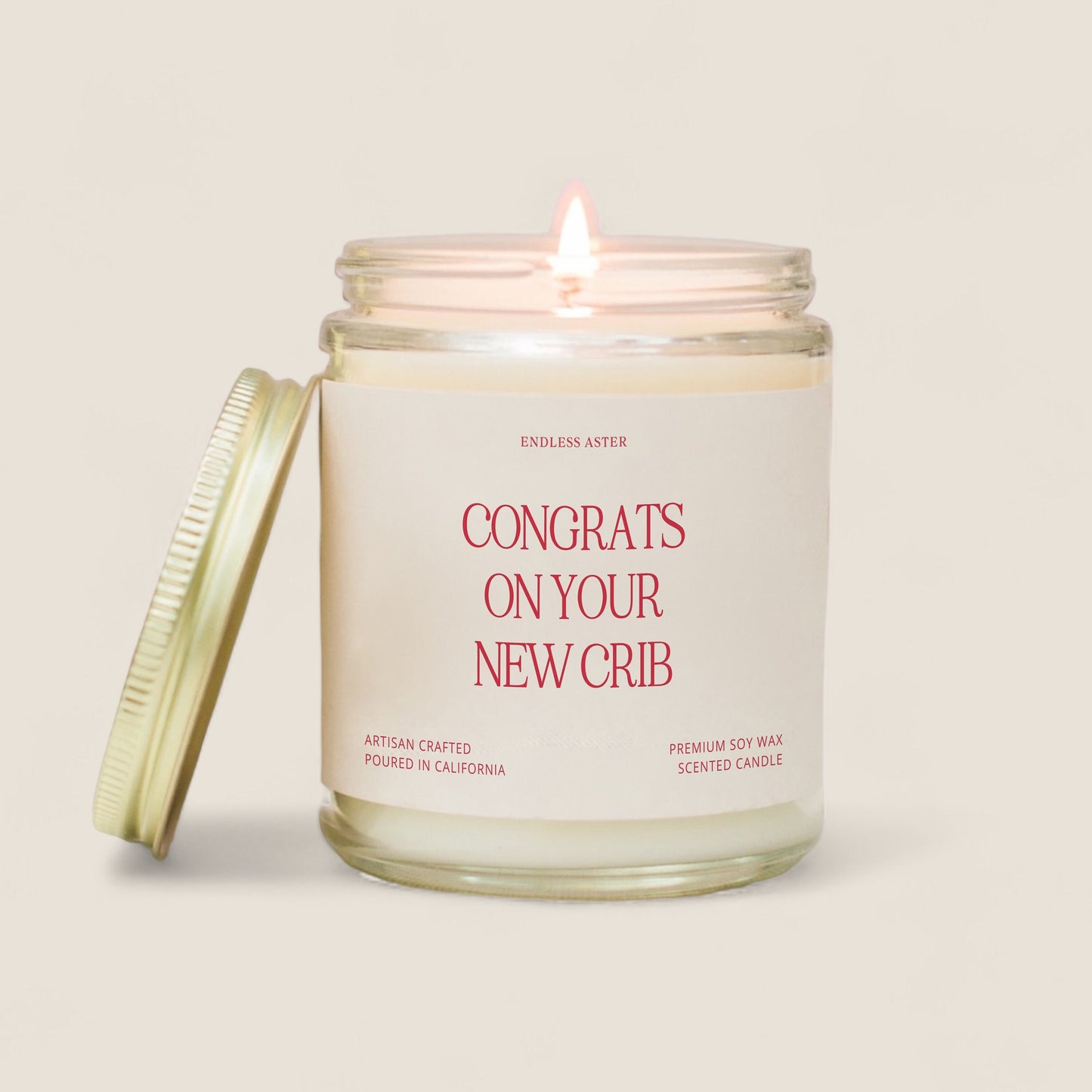 a candle with a label that says congrats on your new crib